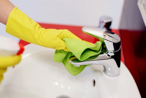 Cleaner vacuuming floors during house cleaning in Kentishtown